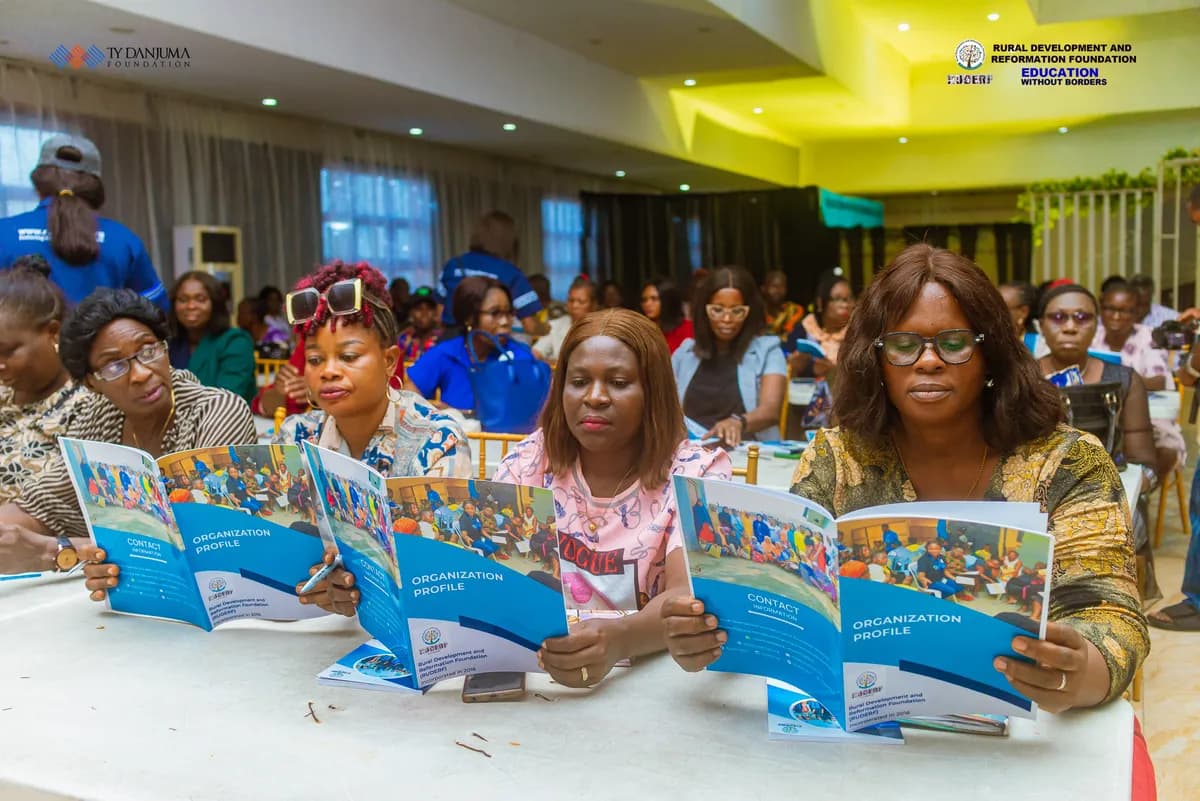 group of women reading through the program brochure of an event organized by ruderf